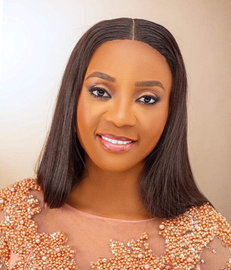Cheta smiling in a peach beaded dress on her birthday, a reminder to keep showing up and evolving.